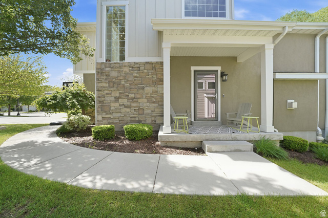 7872 Farm House Lane Midvale, UT 84047 - Photo 3 of 39 Front north facing covered porch. exterior with a covered porch featuring stucco and stone veneer siding