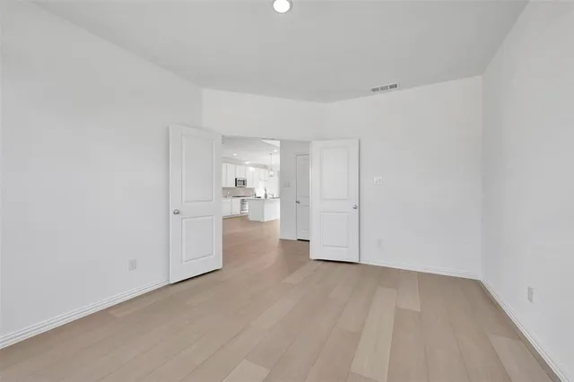 a view of a kitchen with a sink and a refrigerator