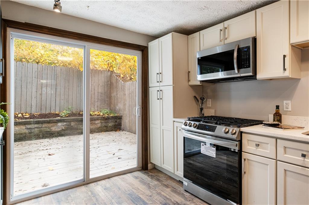 179 Merrimac Street Pittsburgh, PA 15211 - Photo 15 of 37 a kitchen with stainless steel appliances granite countertop a stove and a microwave