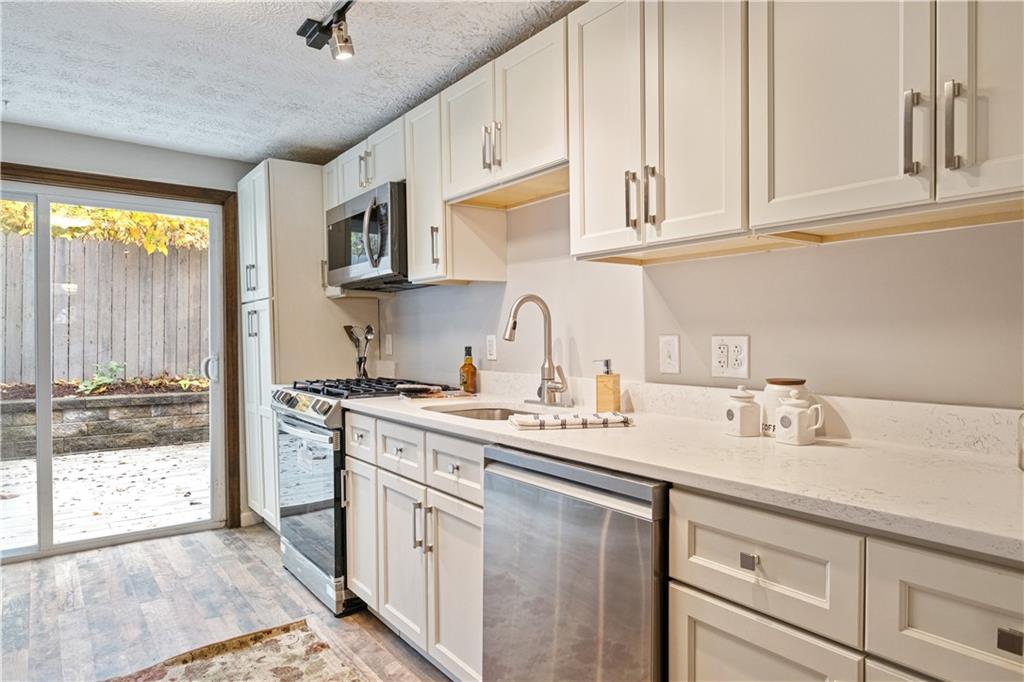 179 Merrimac Street Pittsburgh, PA 15211 - Photo 18 of 37 a kitchen with stainless steel appliances granite countertop a sink stove and cabinets