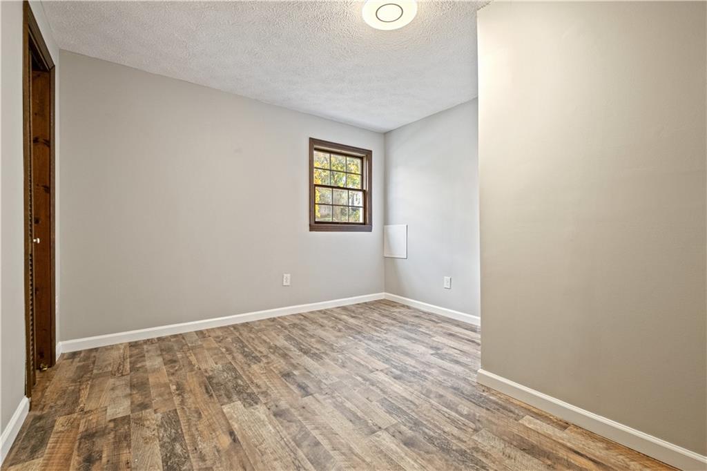 179 Merrimac Street Pittsburgh, PA 15211 - Photo 19 of 37 an empty room with wooden floor and windows