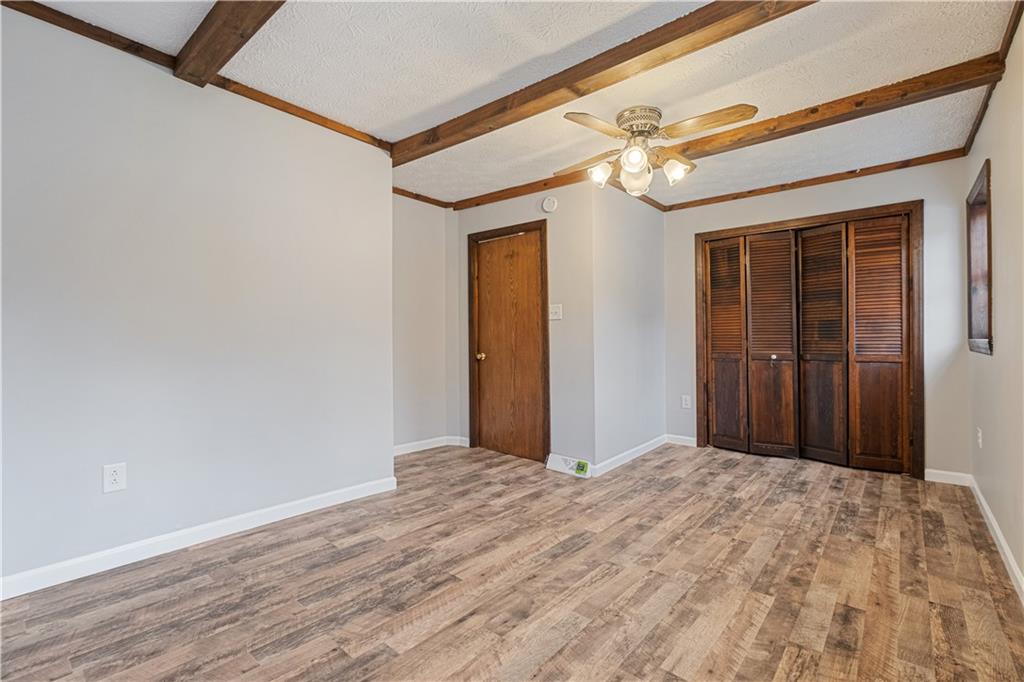 179 Merrimac Street Pittsburgh, PA 15211 - Photo 22 of 37 a view of a hallway with wooden floor and a door