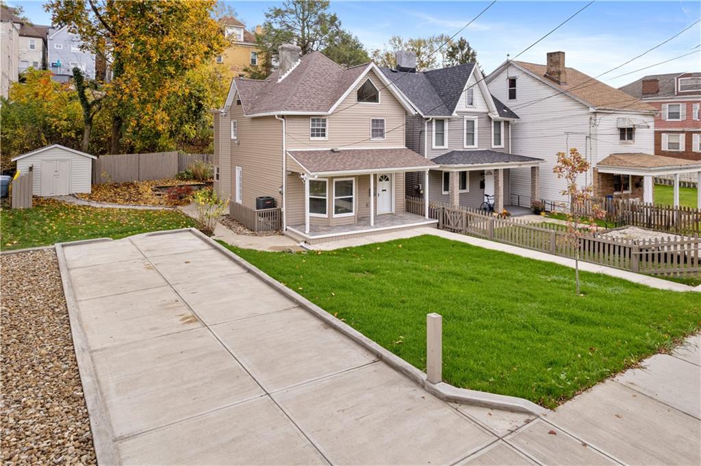 179 Merrimac Street Pittsburgh, PA 15211 - Photo 3 of 37 a front view of a house with a yard