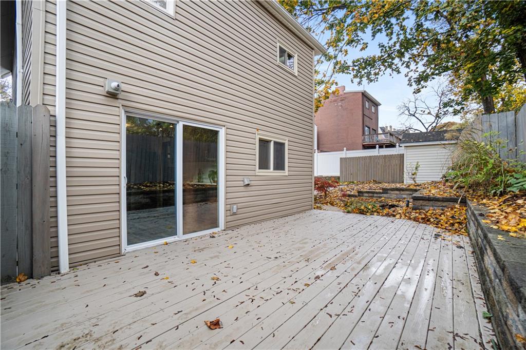 179 Merrimac Street Pittsburgh, PA 15211 - Photo 31 of 37 a view of a house with a wooden deck
