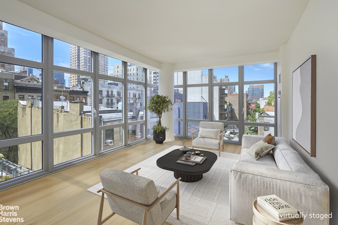 310 West 52nd Street, Unit 5B Manhattan, NY 10019 - Photo 1 of 15 a living room with furniture and a large window