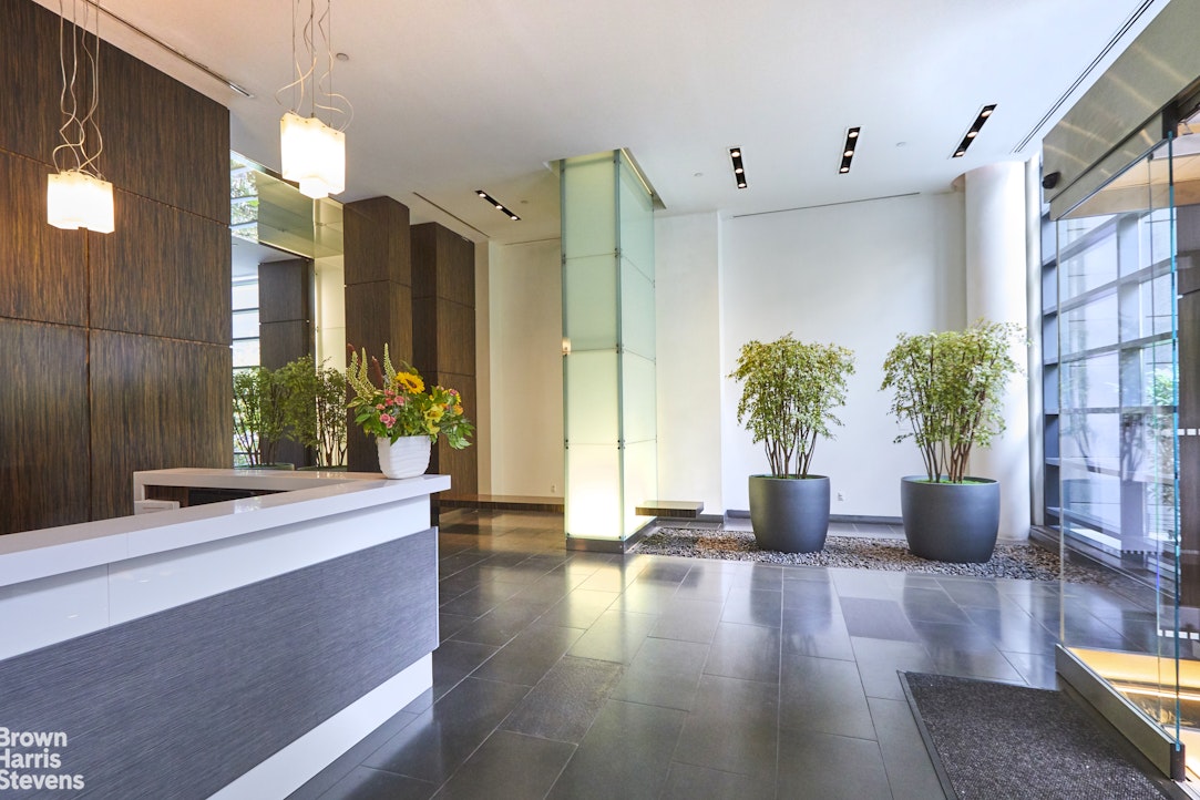 310 West 52nd Street, Unit 5B Manhattan, NY 10019 - Photo 11 of 15 a living room with furniture and a potted plant