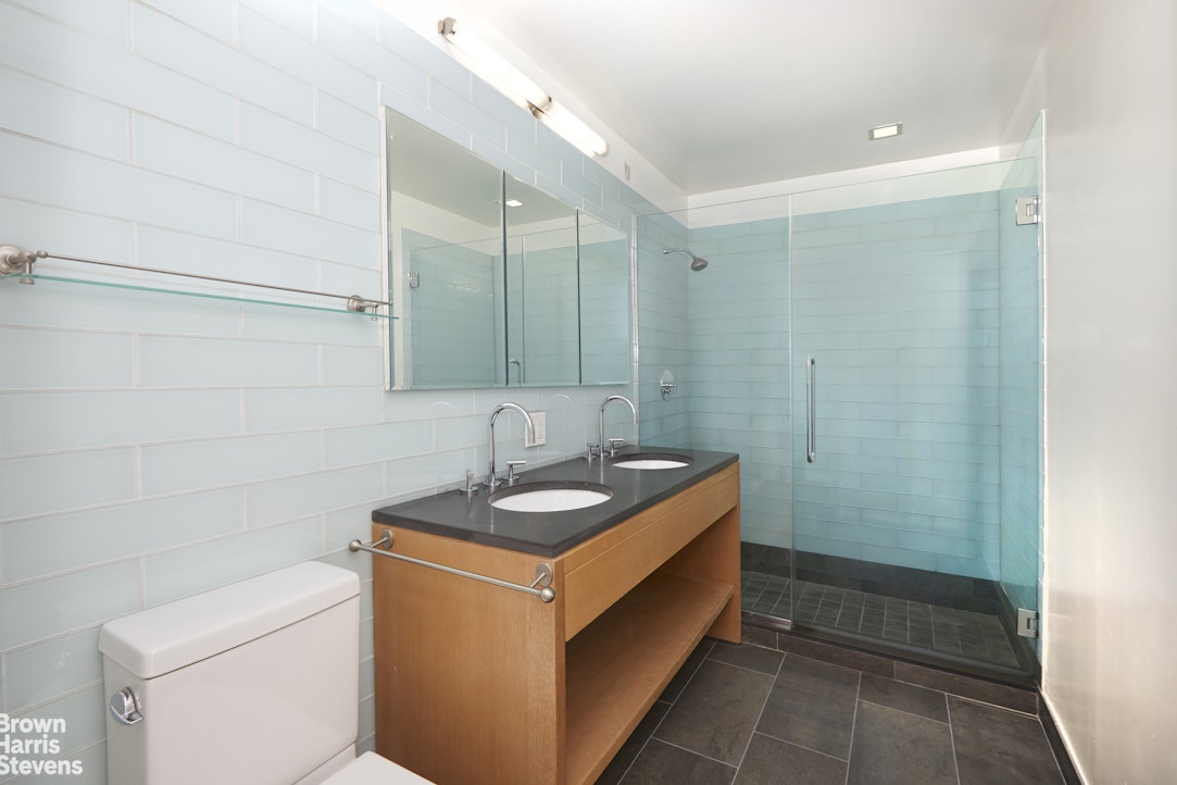 310 West 52nd Street, Unit 5B Manhattan, NY 10019 - Photo 5 of 15 a bathroom with a sink and a mirror
