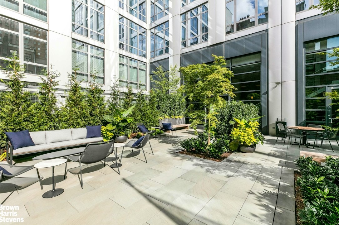 310 West 52nd Street, Unit 5B Manhattan, NY 10019 - Photo 9 of 15 a view of a chair and table in the patio of the house