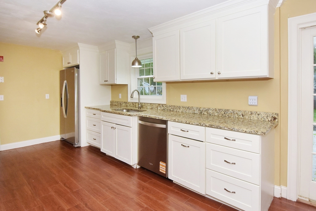 4 Allen Lane Ipswich, MA 01938 - Photo 9 of 30 a kitchen with granite countertop white cabinets and white appliances
