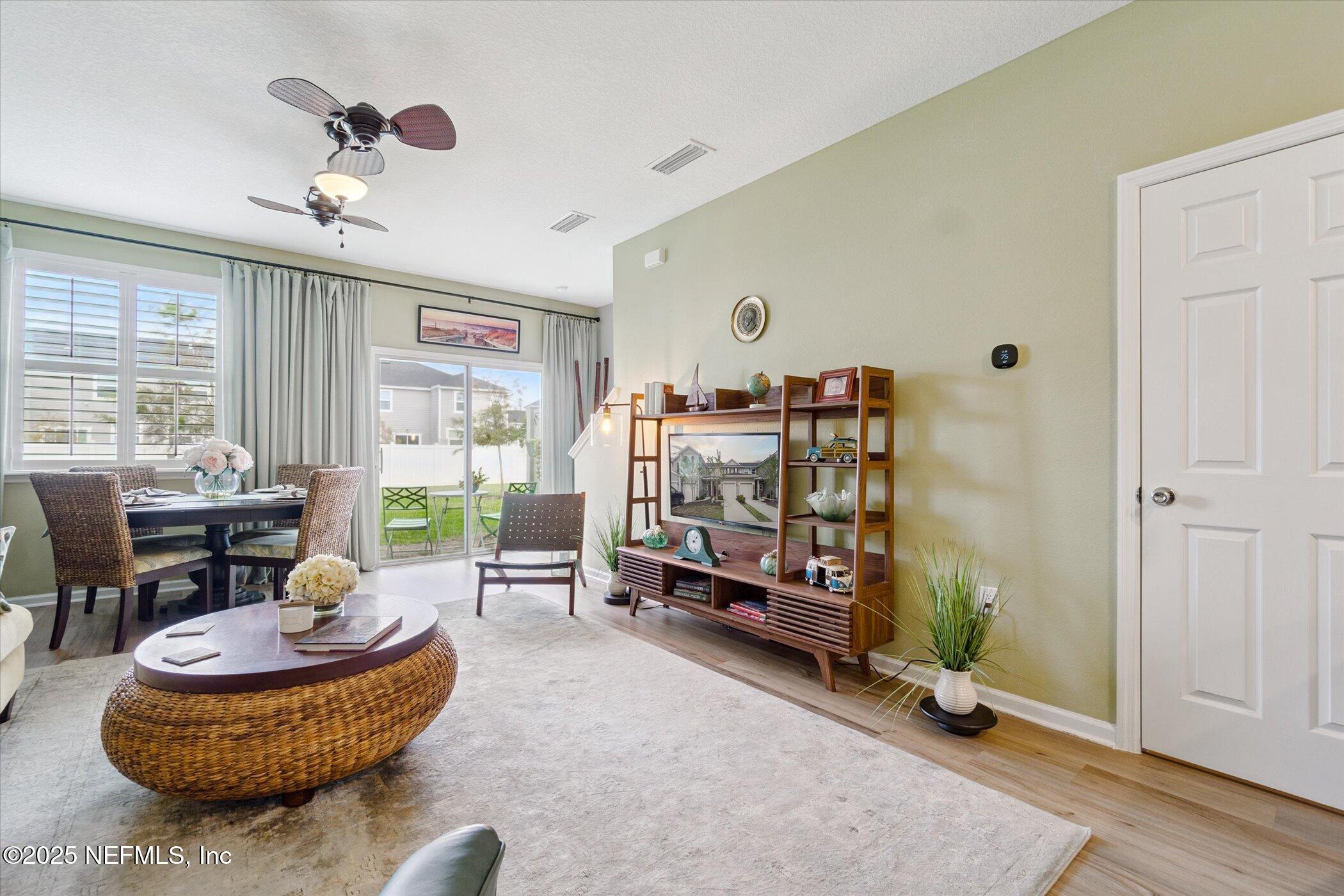7821 Merchants Way Jacksonville, FL 32222 - Photo 14 of 35 a living room with furniture a window and a ceiling fan