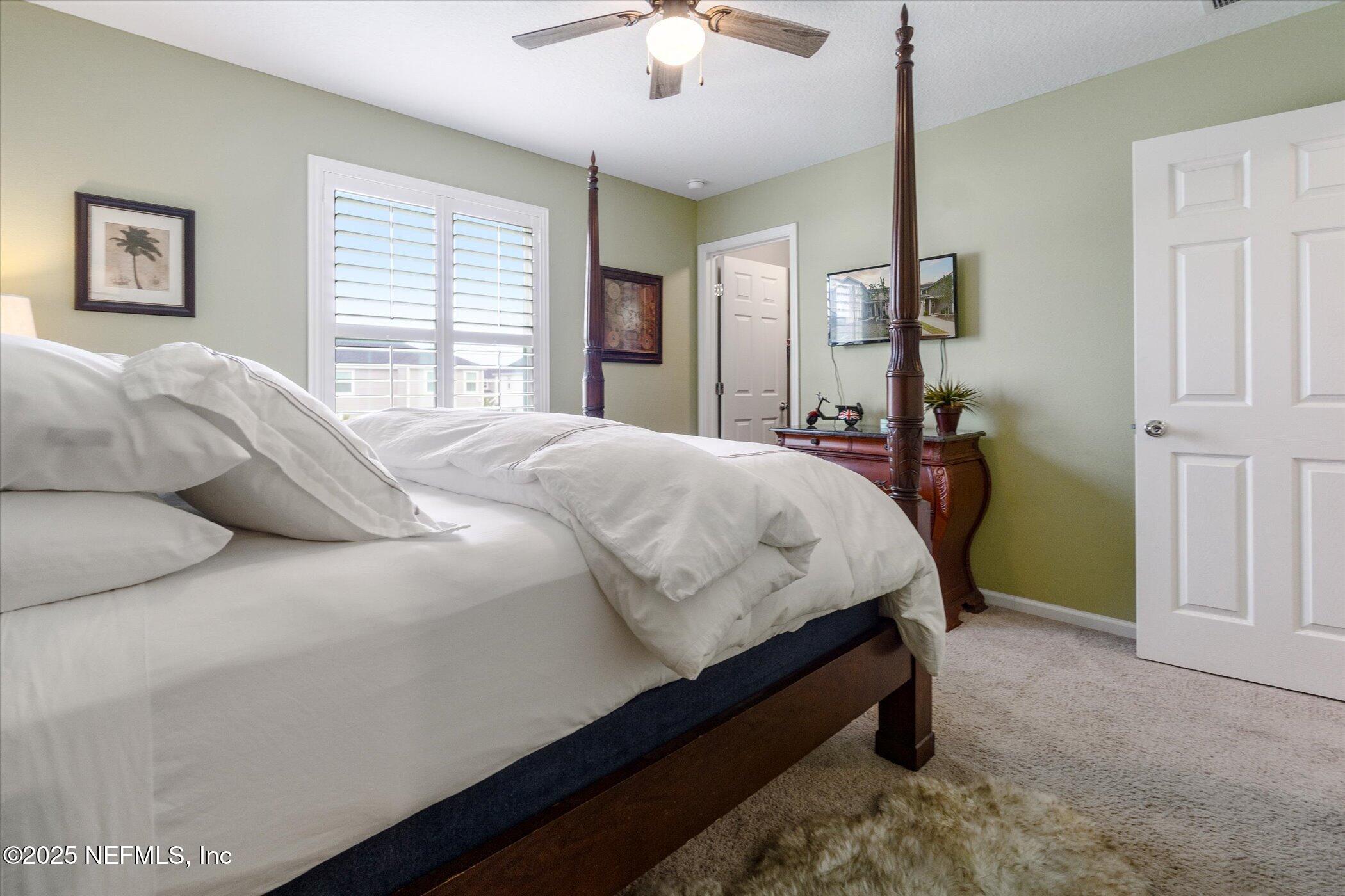 7821 Merchants Way Jacksonville, FL 32222 - Photo 20 of 35 a bed sitting in a bedroom next to a window