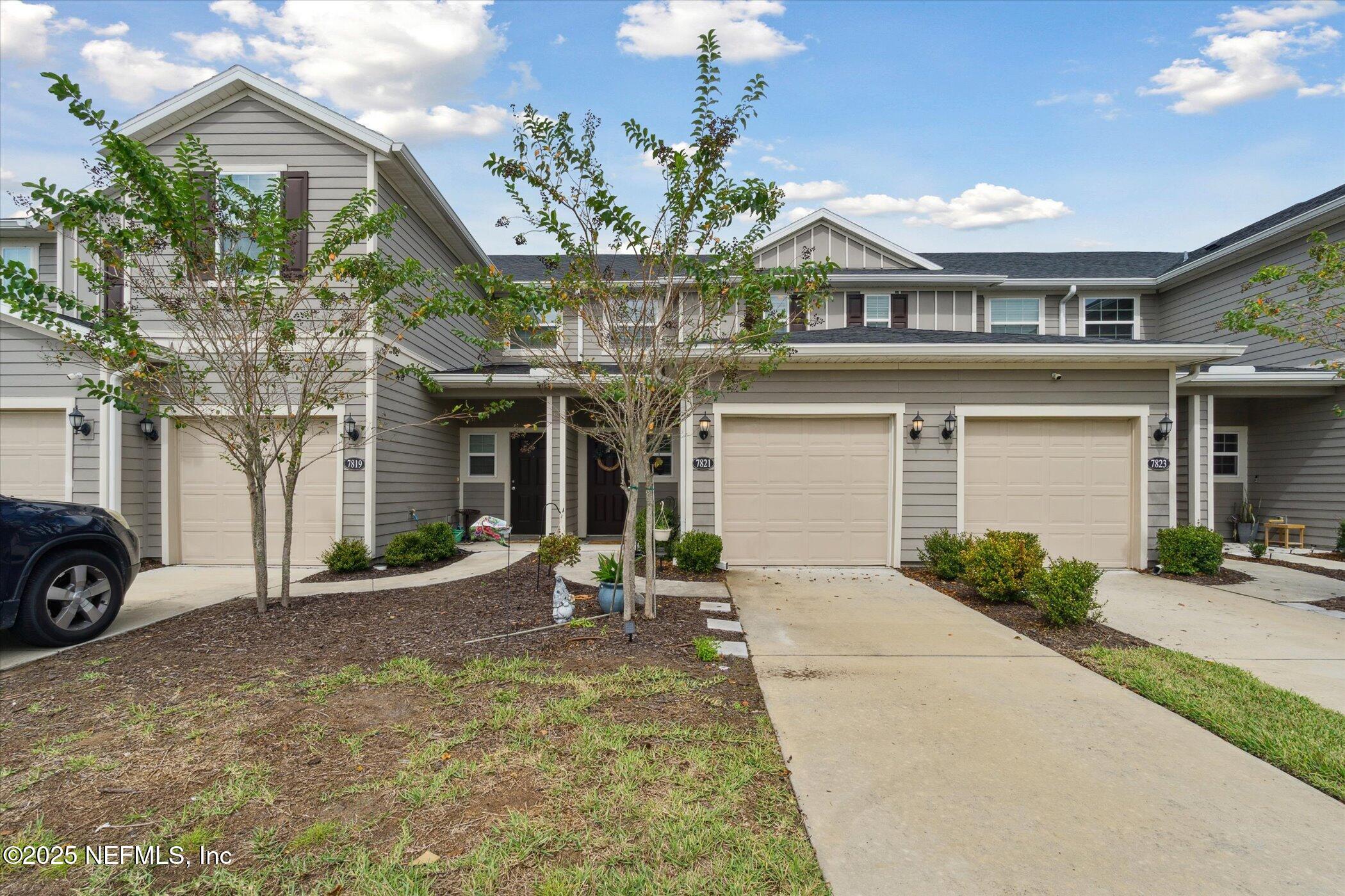7821 Merchants Way Jacksonville, FL 32222 - Photo 35 of 35 a front view of a house with a yard and garage