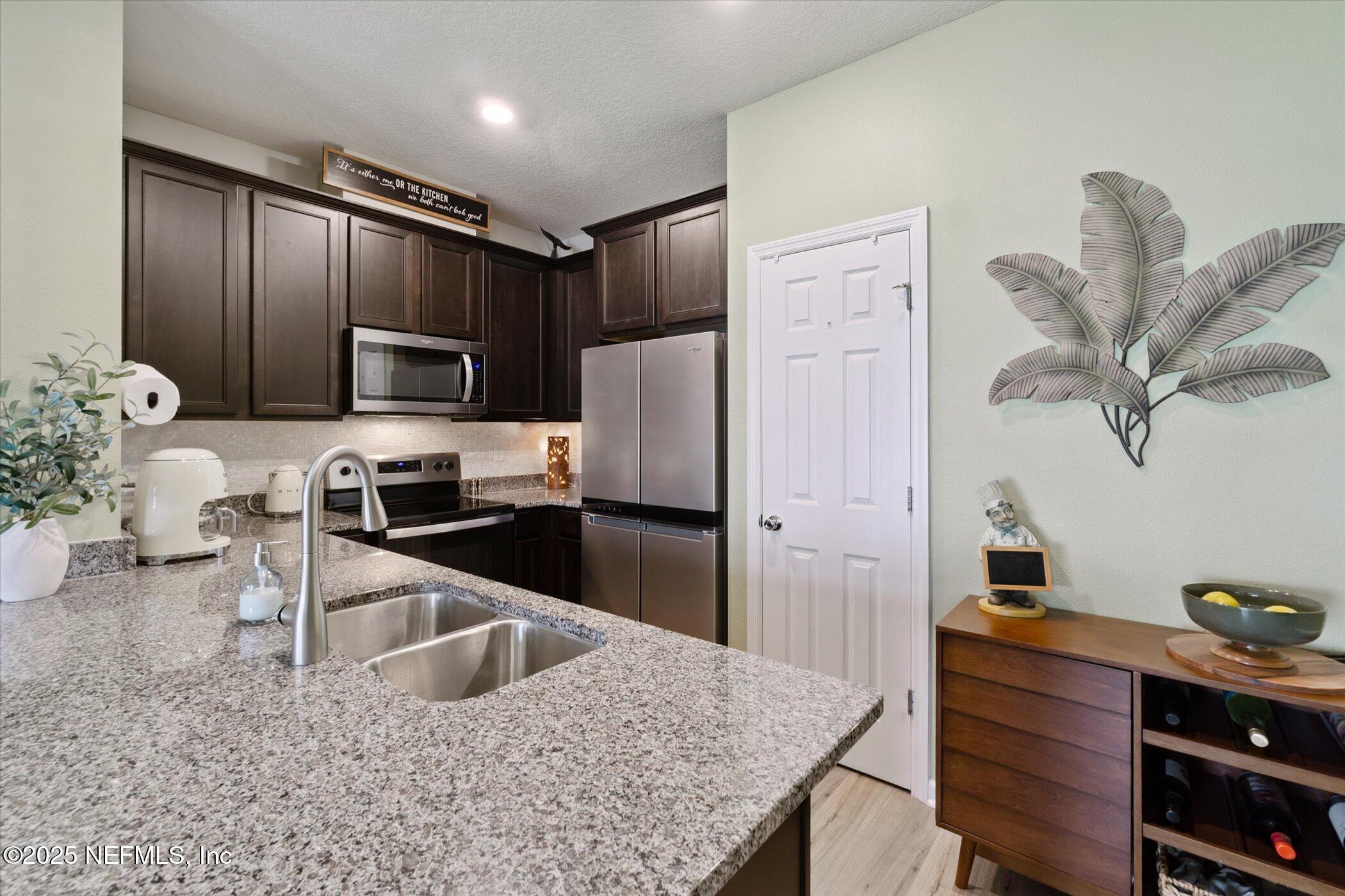 7821 Merchants Way Jacksonville, FL 32222 - Photo 4 of 35 a kitchen with stainless steel appliances granite countertop a refrigerator sink and stove