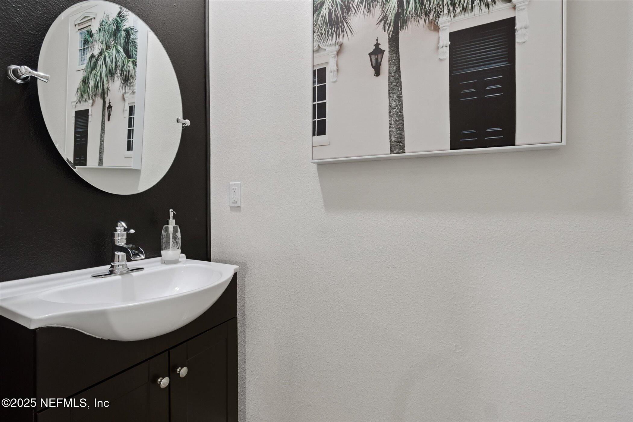 7821 Merchants Way Jacksonville, FL 32222 - Photo 9 of 35 a bathroom with a sink and a mirror