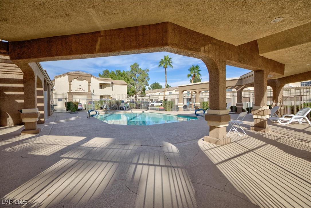 3673 Ian Thomas Street, Unit 102 Las Vegas, NV 89129 - Photo 11 of 15 Community pool with a fenced backyard and a patio