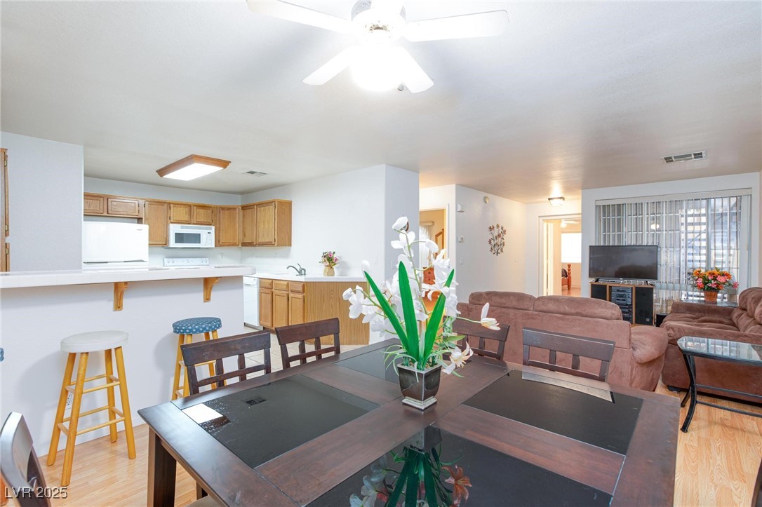 3673 Ian Thomas Street, Unit 102 Las Vegas, NV 89129 - Photo 2 of 15 Dining space with light wood-style flooring and a ceiling fan