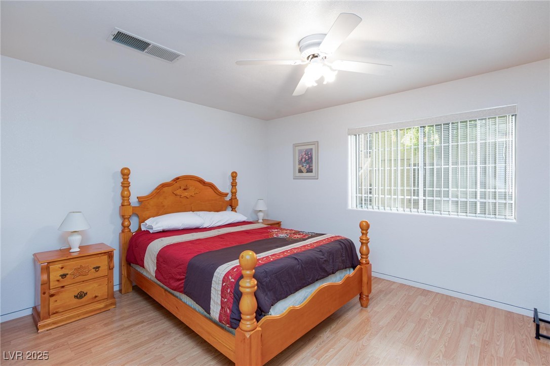 3673 Ian Thomas Street, Unit 102 Las Vegas, NV 89129 - Photo 7 of 15 Bedroom featuring light wood-style floors and ceiling fan