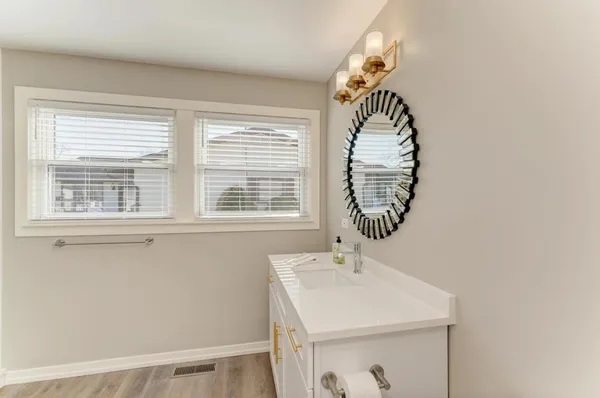 a bathroom with a sink and a window