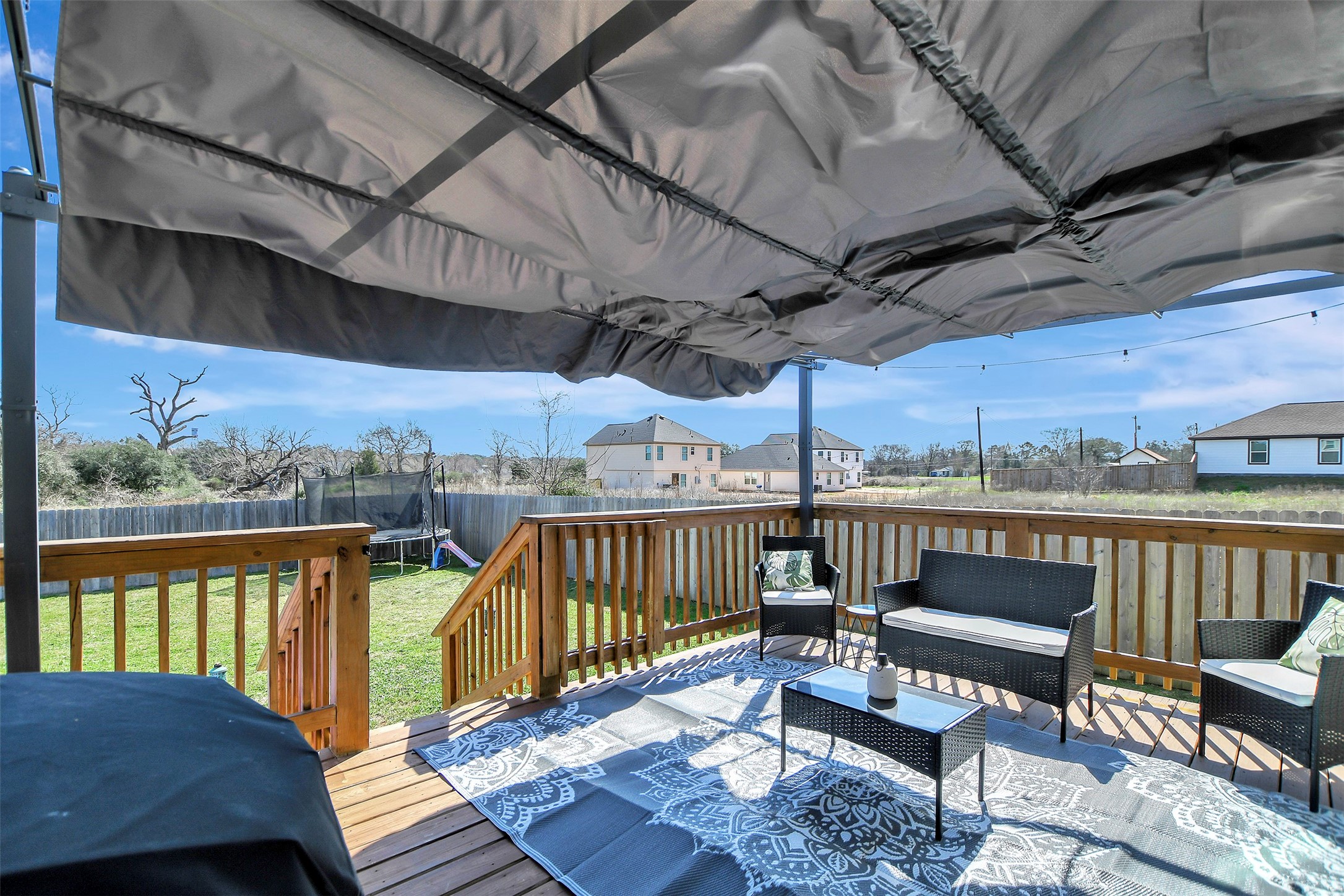 950 21st Street Hempstead, TX 77445 - Photo 29 of 35 Backyard retreat featuring a large deck with covered awning — perfect for relaxing evenings or entertaining guests.
