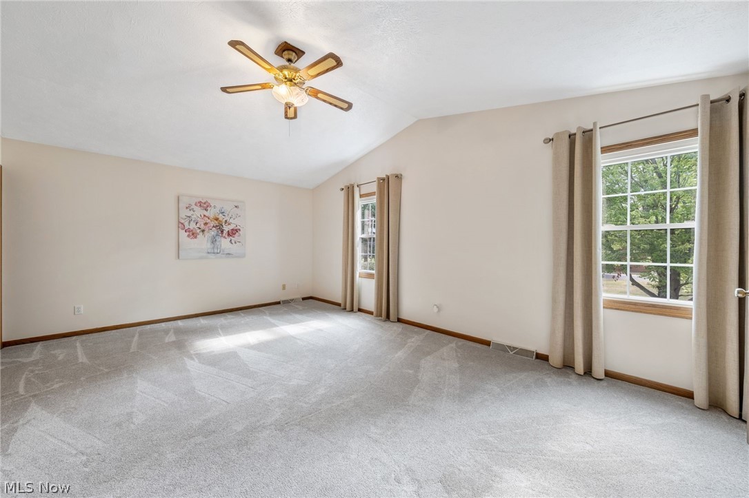 2140 Pickle Road Akron, OH 44312 - Photo 24 of 30 Empty room featuring ceiling fan, lofted ceiling, and light colored carpet