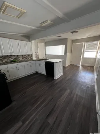 a kitchen with a sink and cabinets