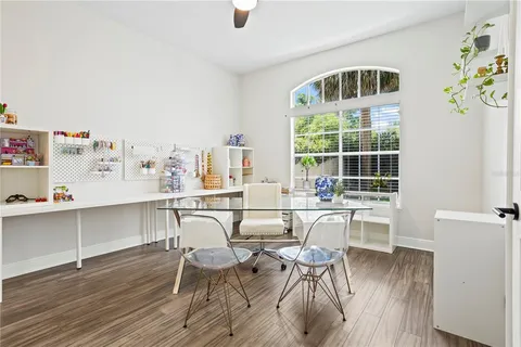 a dining room with furniture a rug and wooden floor