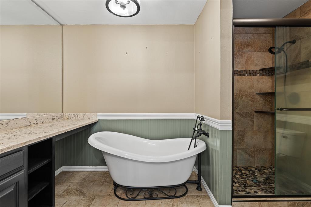 5066 Bob O Link Road Gilmer, TX 75645 - Photo 10 of 30 a bathroom with a granite countertop sink toilet and shower