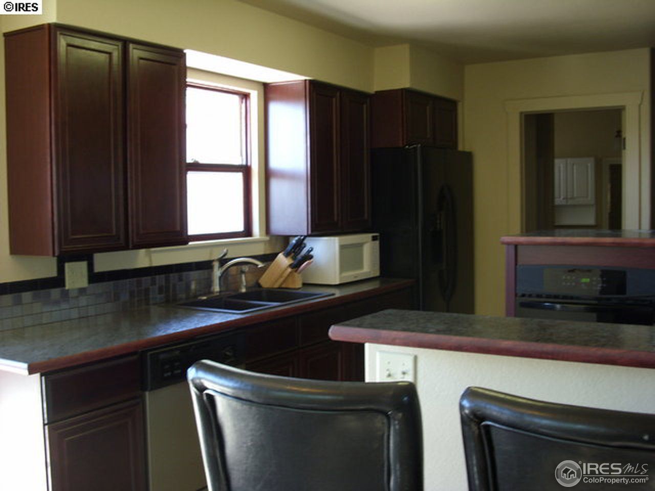 6825 East County Line Road Longmont, CO 80504 - Photo 7 of 22 a kitchen with stainless steel appliances granite countertop a refrigerator and a sink
