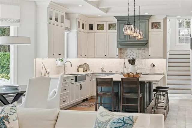 a kitchen with stainless steel appliances granite countertop a stove and a white cabinets