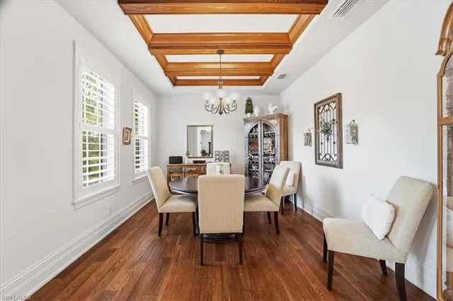 a dining room with furniture a window and wooden floor
