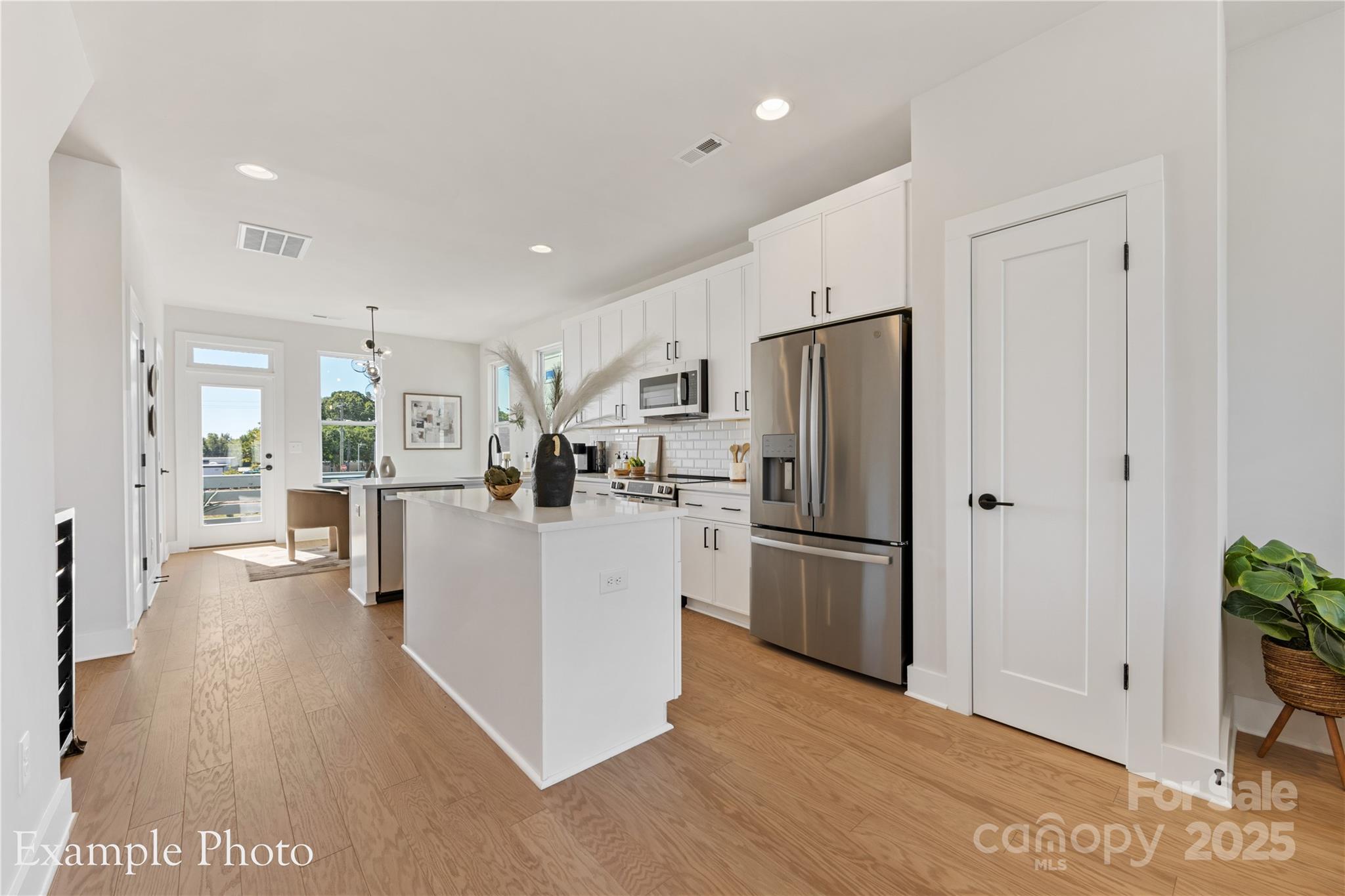 a kitchen with stainless steel appliances a refrigerator and a stove top oven