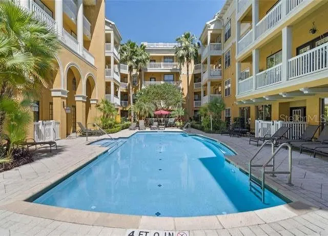 a kitchen with kitchen island granite countertop a sink a stove and a microwave