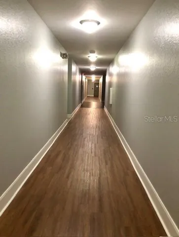a view of a living room and a porch with wooden floor
