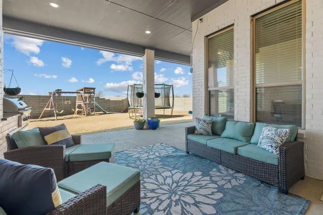 a living room with furniture and large windows