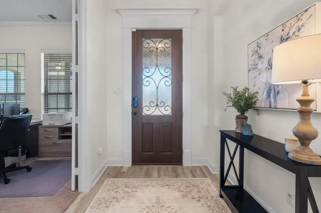 a view of a workspace with furniture and a window