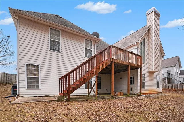 a view of a house with wooden deck