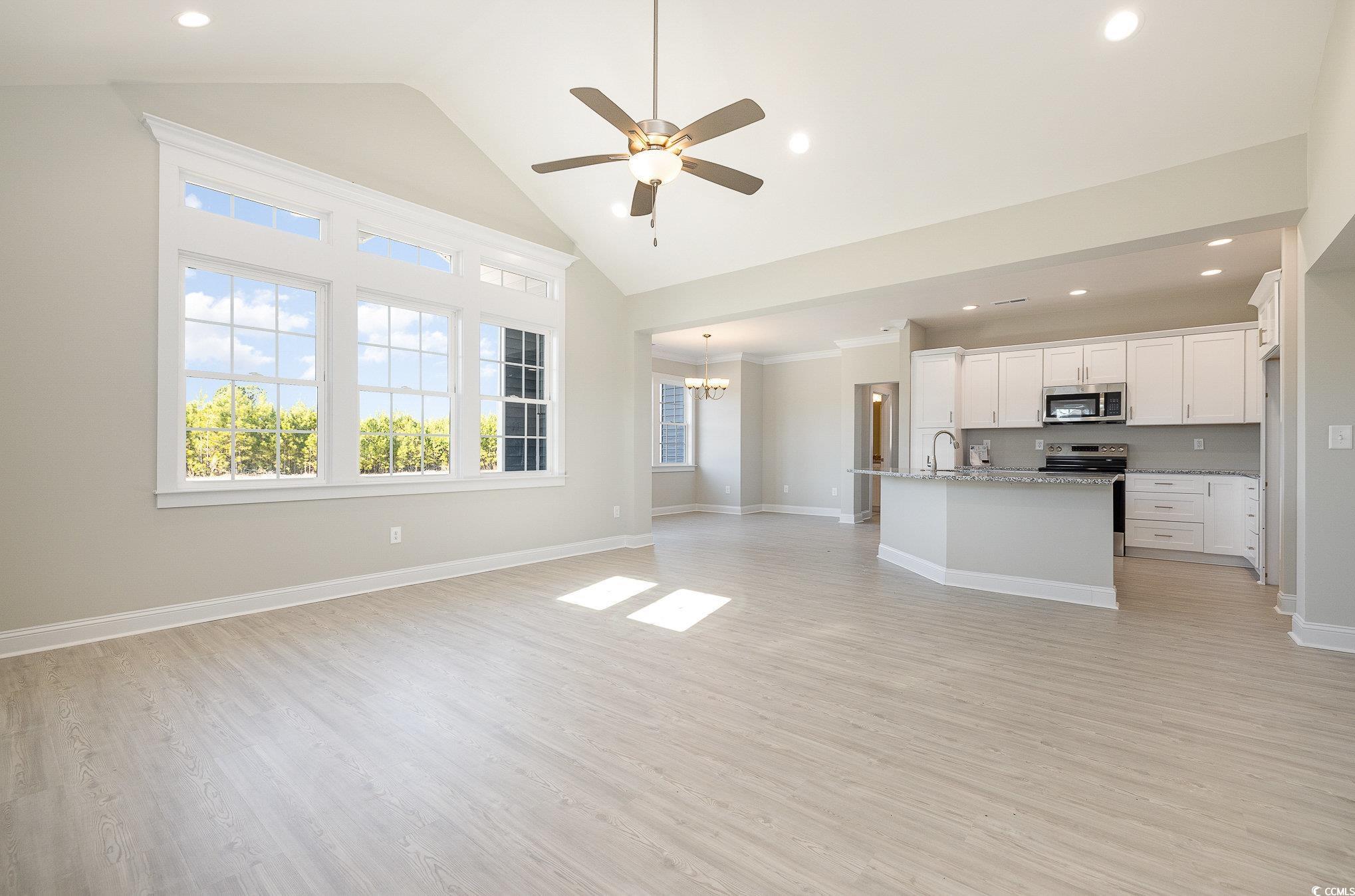381 Log Cabin Road Loris, SC 29569 - Photo 11 of 35 Unfurnished living room with sink, high vaulted ce
