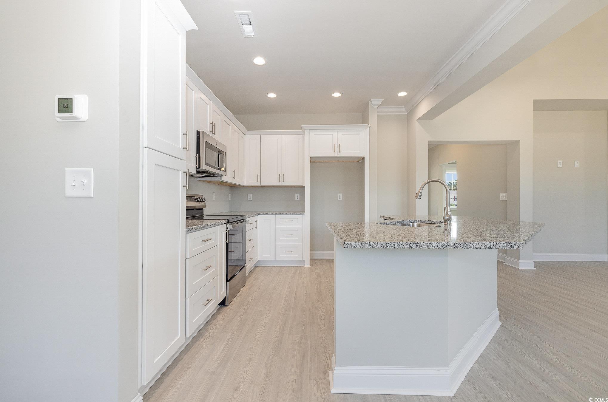 381 Log Cabin Road Loris, SC 29569 - Photo 13 of 35 Kitchen with white cabinets, light stone counters,