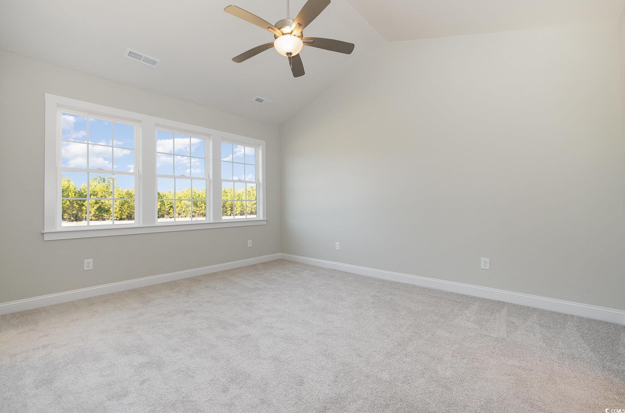 381 Log Cabin Road Loris, SC 29569 - Photo 18 of 35 Carpeted empty room with ceiling fan and vaulted c