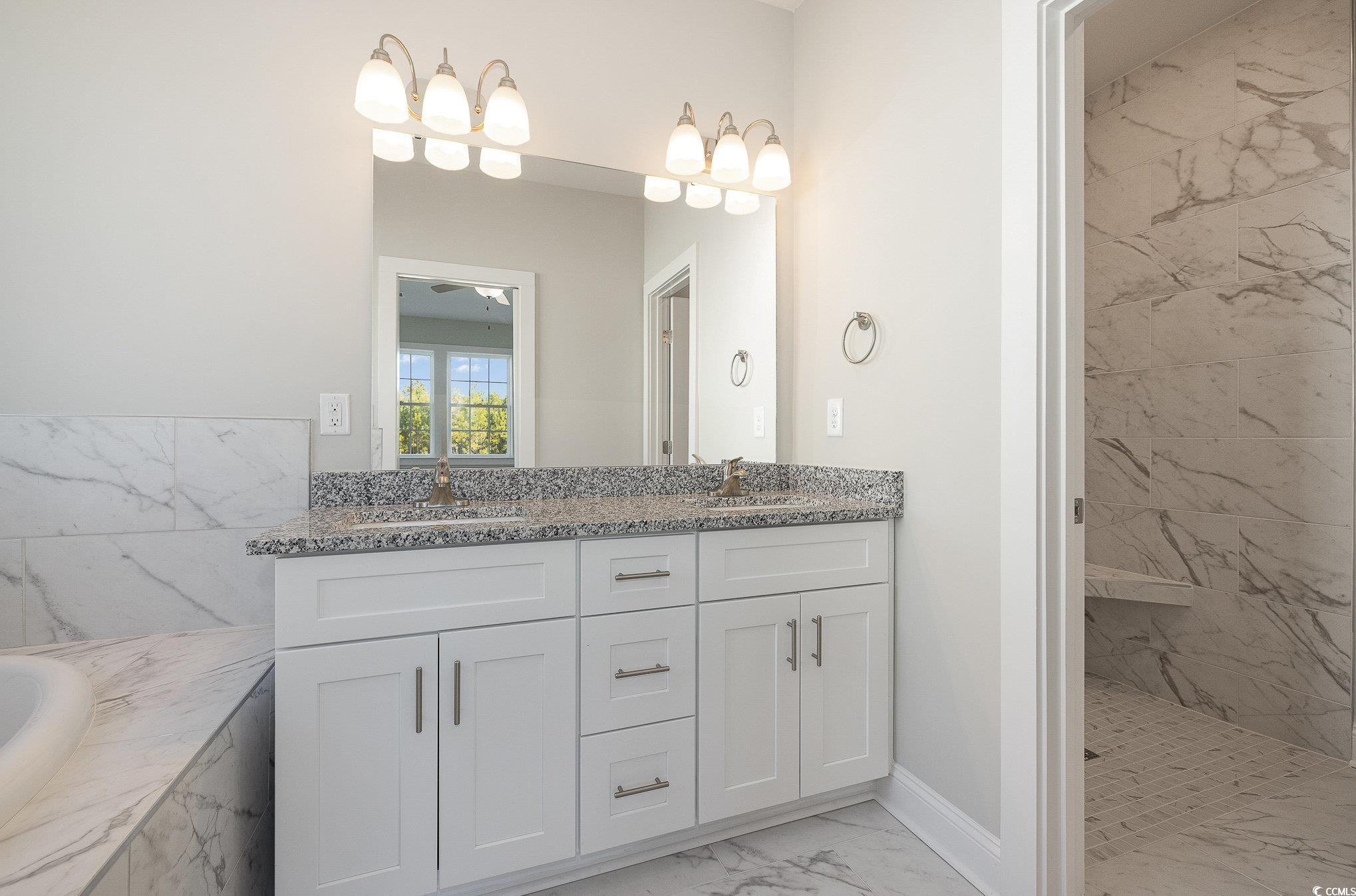 381 Log Cabin Road Loris, SC 29569 - Photo 21 of 35 Bathroom with ceiling fan, vanity, and tiled showe
