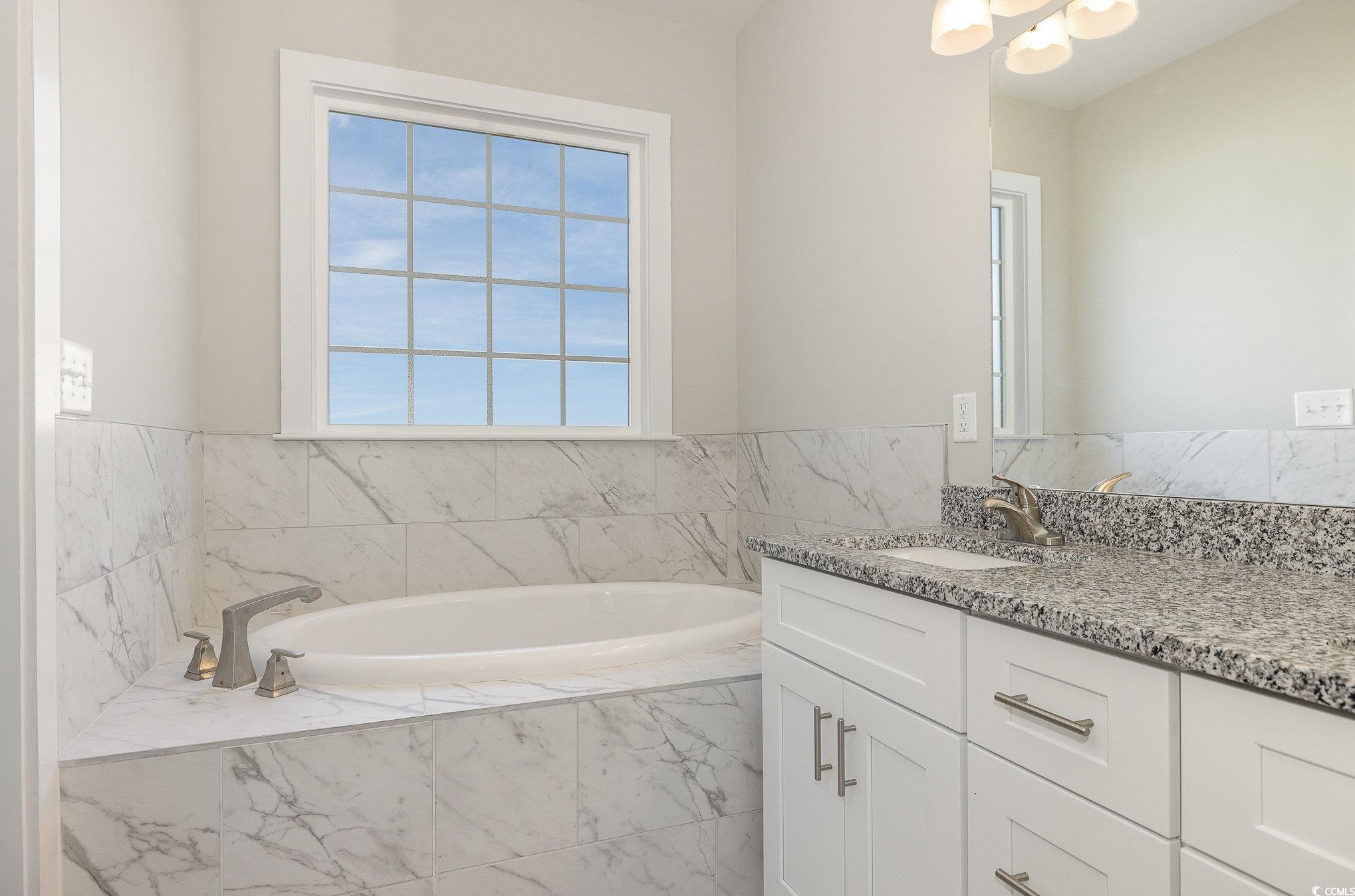381 Log Cabin Road Loris, SC 29569 - Photo 22 of 35 Bathroom with vanity and tiled tub