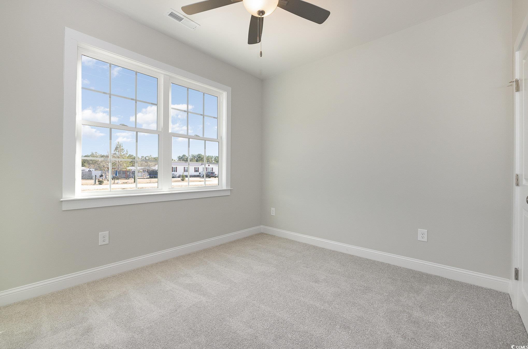 381 Log Cabin Road Loris, SC 29569 - Photo 24 of 35 Carpeted empty room featuring ceiling fan and a he