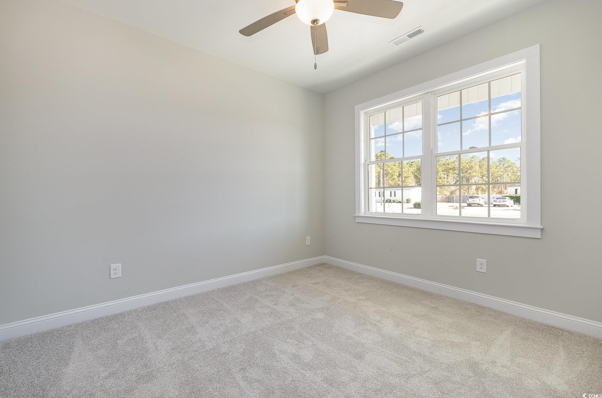 381 Log Cabin Road Loris, SC 29569 - Photo 26 of 35 Empty room featuring ceiling fan and light carpet