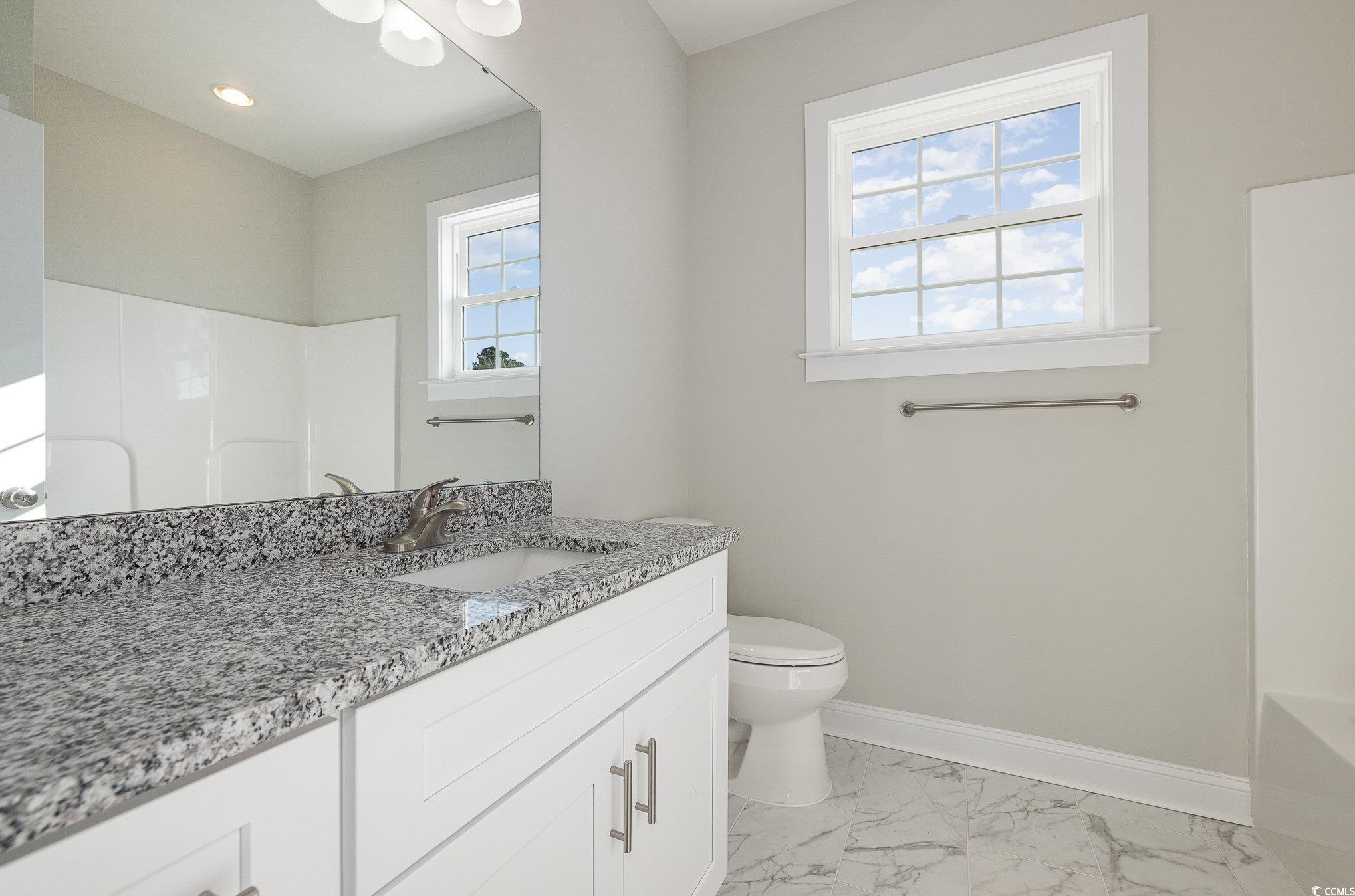 381 Log Cabin Road Loris, SC 29569 - Photo 27 of 35 Full bathroom featuring vanity, toilet, and tub /