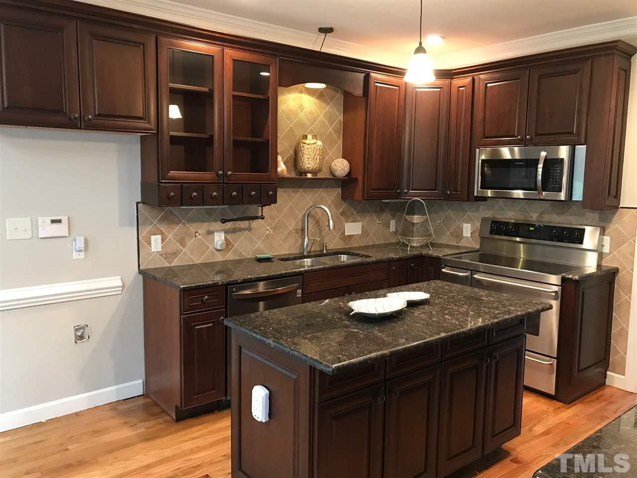 1416 Shadowview Court Raleigh, NC 27614 - Photo 2 of 28 a kitchen with a sink stove and microwave