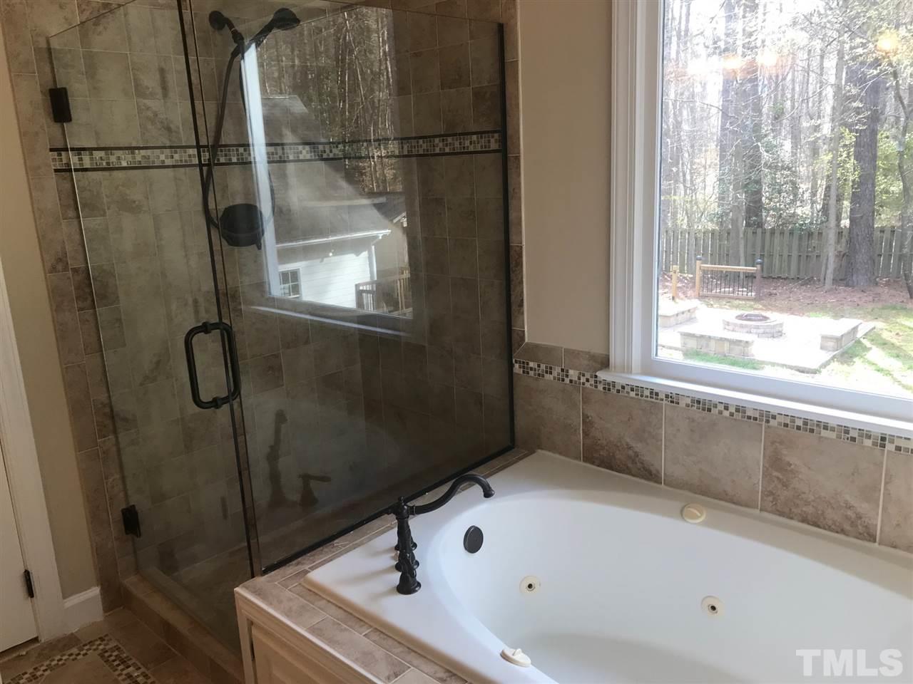 1416 Shadowview Court Raleigh, NC 27614 - Photo 13 of 28 a bathroom with a bath tub and a shower