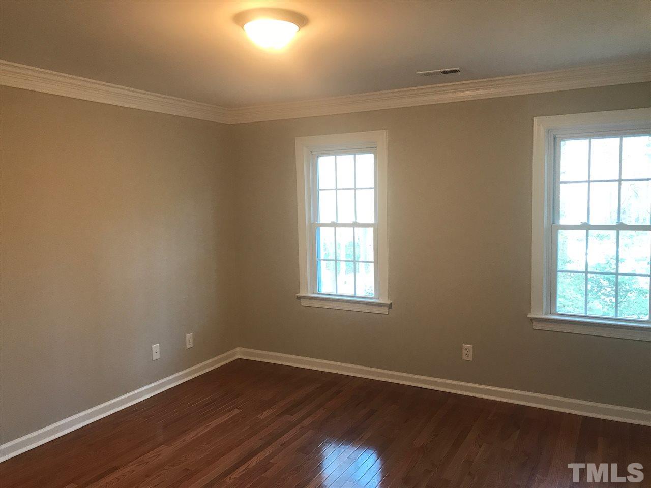1416 Shadowview Court Raleigh, NC 27614 - Photo 15 of 28 an empty room with wooden floor and windows