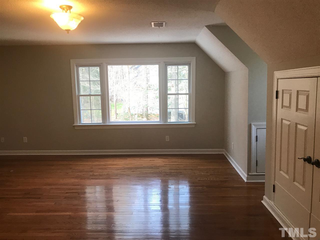 1416 Shadowview Court Raleigh, NC 27614 - Photo 17 of 28 a view of an empty room with wooden floor and a window