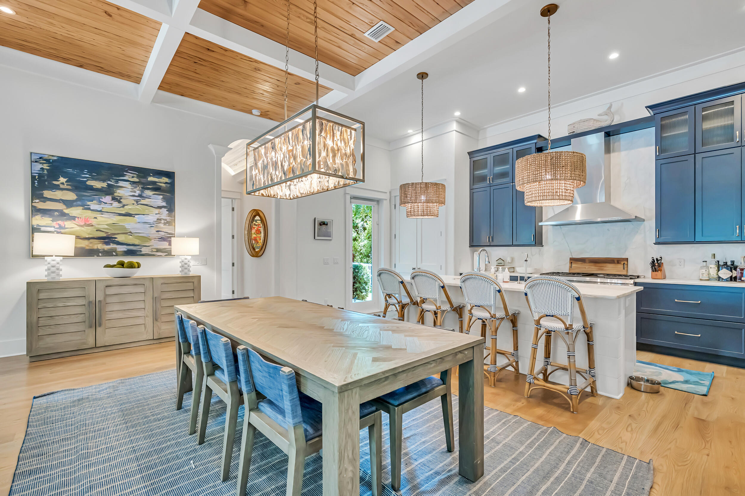 84 Pine Crest Circle Inlet Beach, FL 32461 - Photo 23 of 74 a kitchen with stainless steel appliances granite countertop a kitchen island a stove a table and chairs in it
