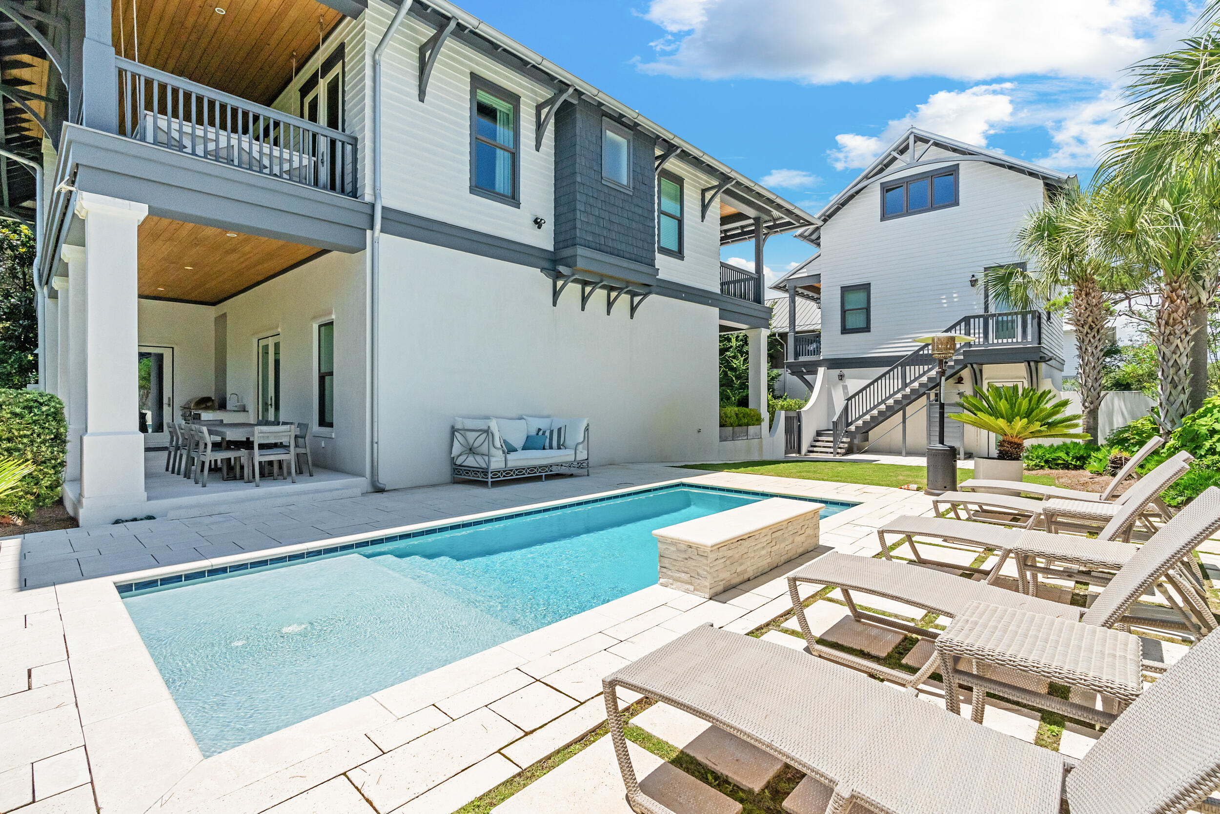 84 Pine Crest Circle Inlet Beach, FL 32461 - Photo 31 of 74 a view of a patio with table and chairs with wooden floor and fence